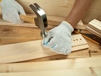 Close-up of carpenter hammering wood
