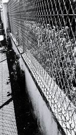 High angle view of chainlink fence in city during winter