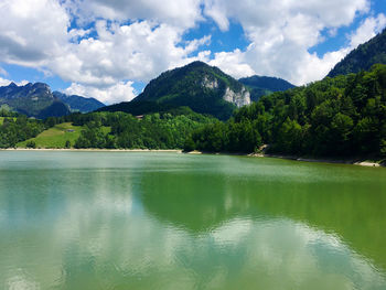 Scenic view of lake and mountains against sky