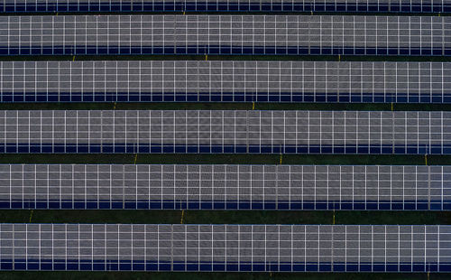 Aerial view of photovoltaic solar panel plant on a field