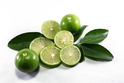 Close-up of green fruits against white background