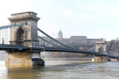 Low angle view of szechenyi chain bridge over river against sky