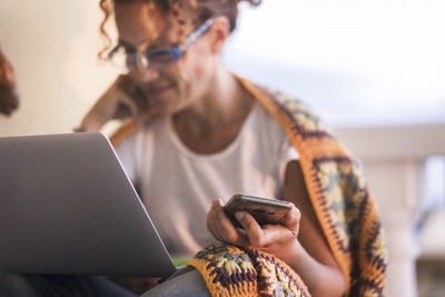 Midsection of man using mobile phone