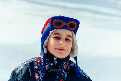 Close-up portrait of boy wearing warm clothing during winter