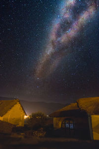 Scenic view of illuminated building against sky at night