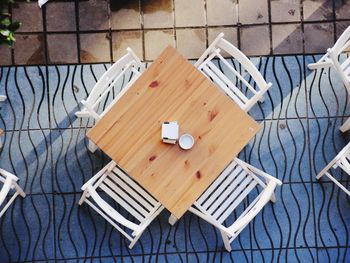 High angle view of empty chairs on table