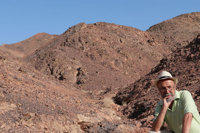 Senior man sitting on mountain