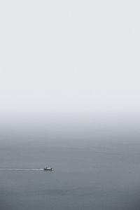 High angle view of boat sailing in sea against clear sky