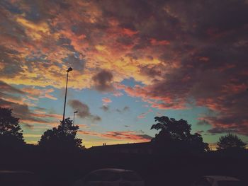 Silhouette of trees against cloudy sky