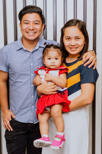 Portrait of happy family with child smiling