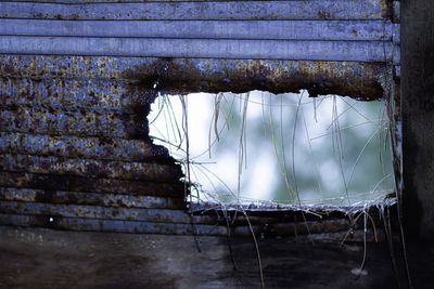 Abandoned building seen through broken window