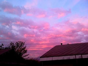 High section of built structure against cloudy sky