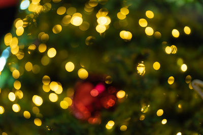 Defocused image of illuminated christmas lights at night