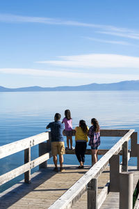 A family enjoying a pier on a beautiful day in south lake tahoe, ca
