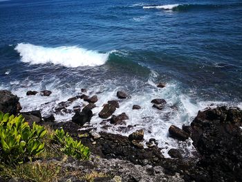 High angle view of rocks on sea shore