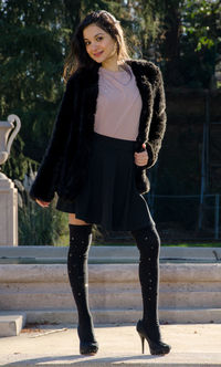 Portrait of smiling young woman standing outdoors
