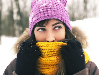 Close-up of woman in hat looking away during winter
