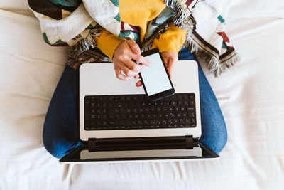 High angle view of woman using mobile phone at home