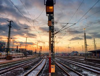 Railroad tracks against cloudy sky