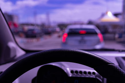 Close-up of car on road seen through windshield