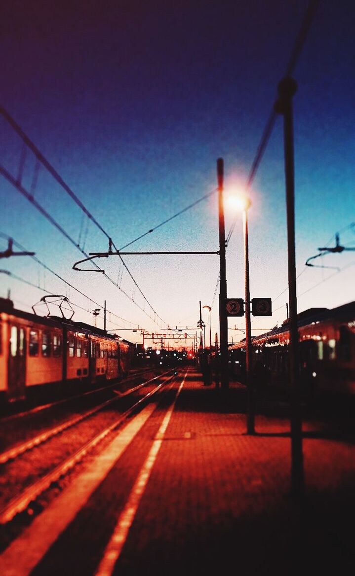 TRAIN ON RAILROAD TRACKS AGAINST CLEAR SKY