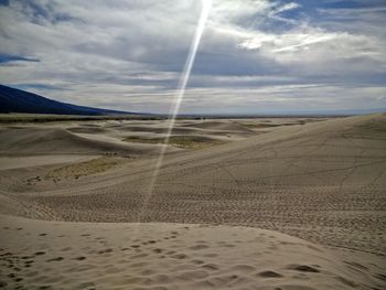 Scenic view of landscape against cloudy sky