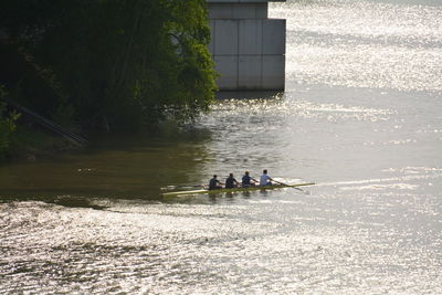 People rowing in water