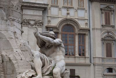 Low angle view of statue against building