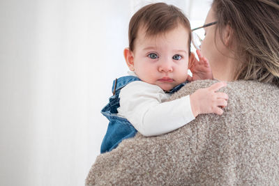 Close-up of cute baby girl at home