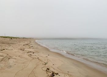 Scenic view of beach against clear sky