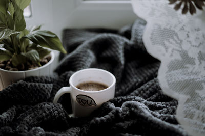 Close-up of coffee cup on table at home