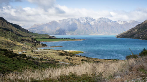 Scenic view of lake and mountains against sky