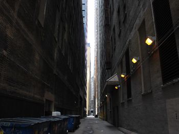 Road amidst buildings at night