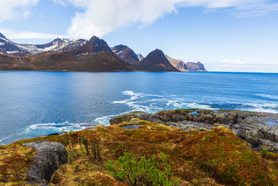 Scenic view of sea and mountains against sky