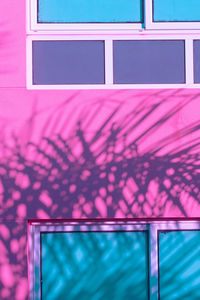 Low angle view of pink window on building