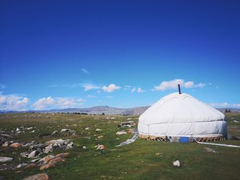 Tent on field against sky