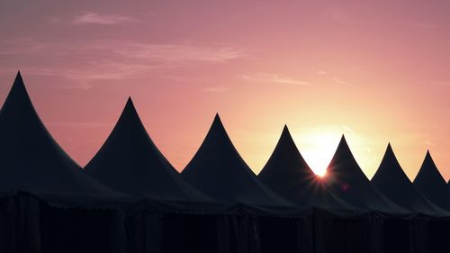 Built structures against sky during sunset