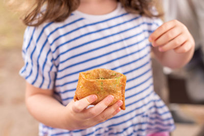 Midsection of woman holding ice cream