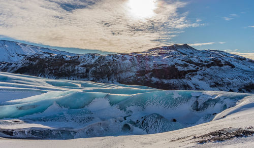 Scenic view of mountain and glacier against sky