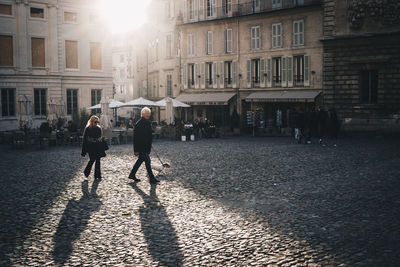 People walking in front of buildings