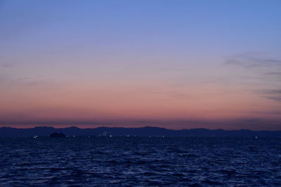 Scenic view of sea against romantic sky at sunset