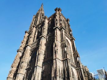 Low angle view of building against clear blue sky