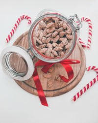 High angle view of christmas ornaments on table against white background