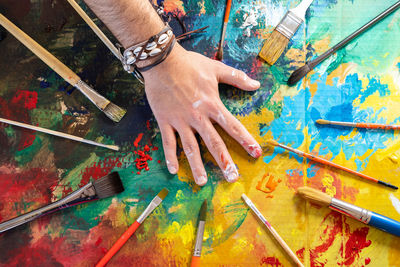 High angle view of man hand against graffiti