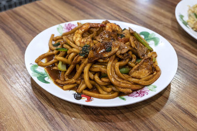 High angle view of stir fried noodles in plate on table