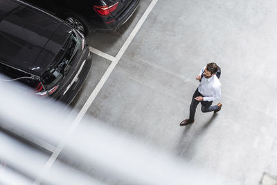 High angle view of man on car moving in city