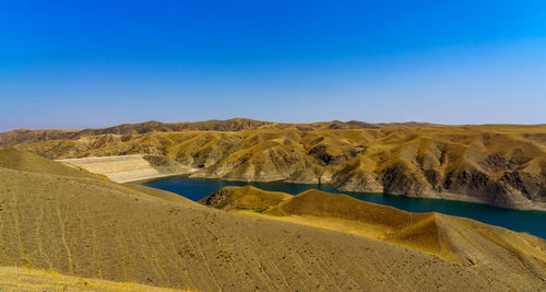 Scenic view of mountains against clear blue sky