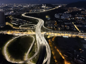 High angle view of illuminated buildings in city at night