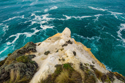 Aerial view of rocky coastline by sea