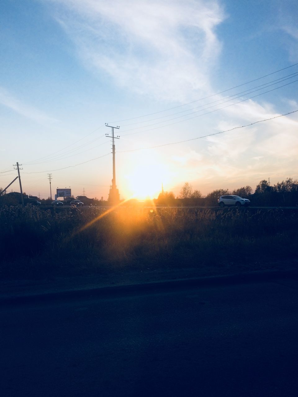 sky, sunset, technology, nature, electricity pylon, electricity, sunlight, cloud - sky, no people, cable, power line, sun, road, beauty in nature, field, connection, fuel and power generation, transportation, silhouette, power supply, outdoors, telephone line